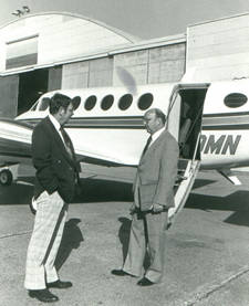 Two men near airplane