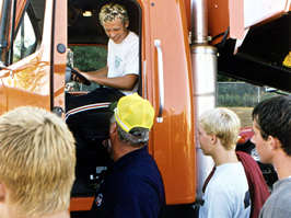 Kids surrounding orange truck