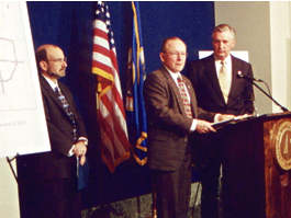 3 men at a podium