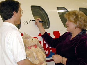 Woman signing name on plane