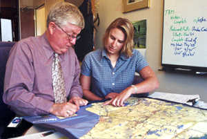 Man, woman looking at map