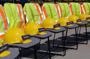 Chairs draped in safety vests, hard hats