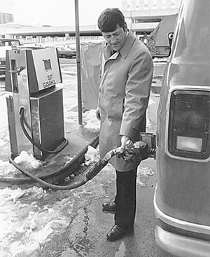 Man putting gas in van 