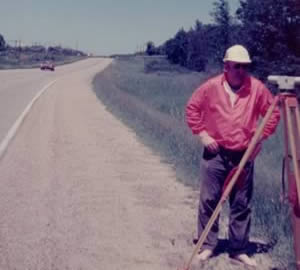 Barefoot man surveying road