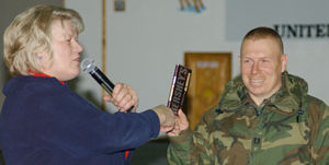 Lt governor handing chocolate to soldier