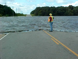 Man looking at road covered by water