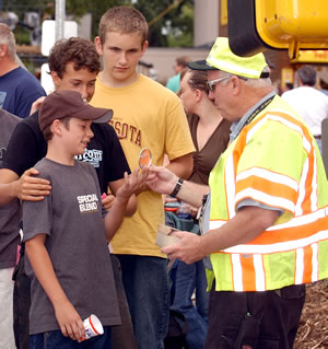 Man in safety vest instructs kids