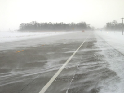 Snow blowing across highway