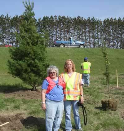 2 women planting trees
