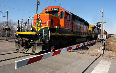 Photo of train at rail crossing.