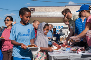 Photo of community members getting food at Celebrate Snelling event.