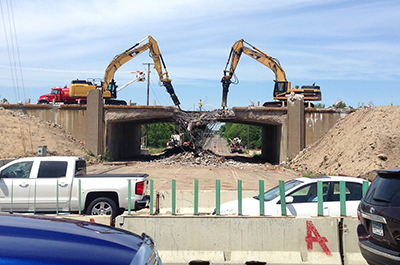 Heavy equipment demolishes Lexington Avenue bridge