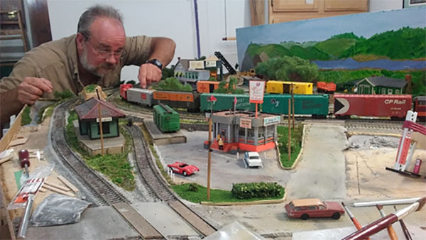 Pat Osborn works on his model railroad.