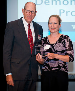 Jay Kiedrowski and Jennifer Zink holding an award