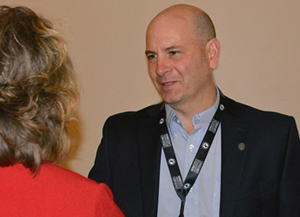 Pat Huston speaks to woman after his presentation at Minnesota's Transportation Conference