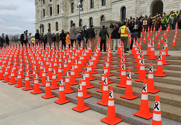 Orange cones on capitol steps during news conference.