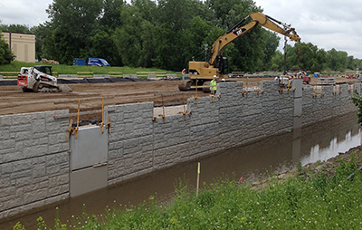 Crews operating machinery are on the Nine Mile Creek Causeway in June 