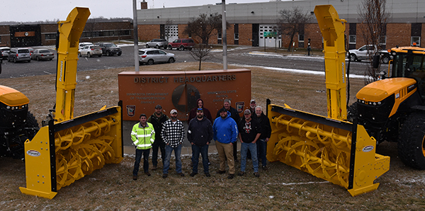 Photo: District staff by new snow blower tractors.
